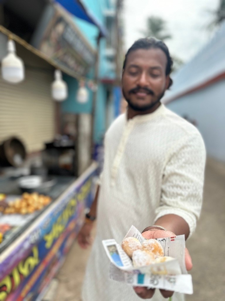 Buying Mathura Cake from a street vendor in Puri during Rath Yatra